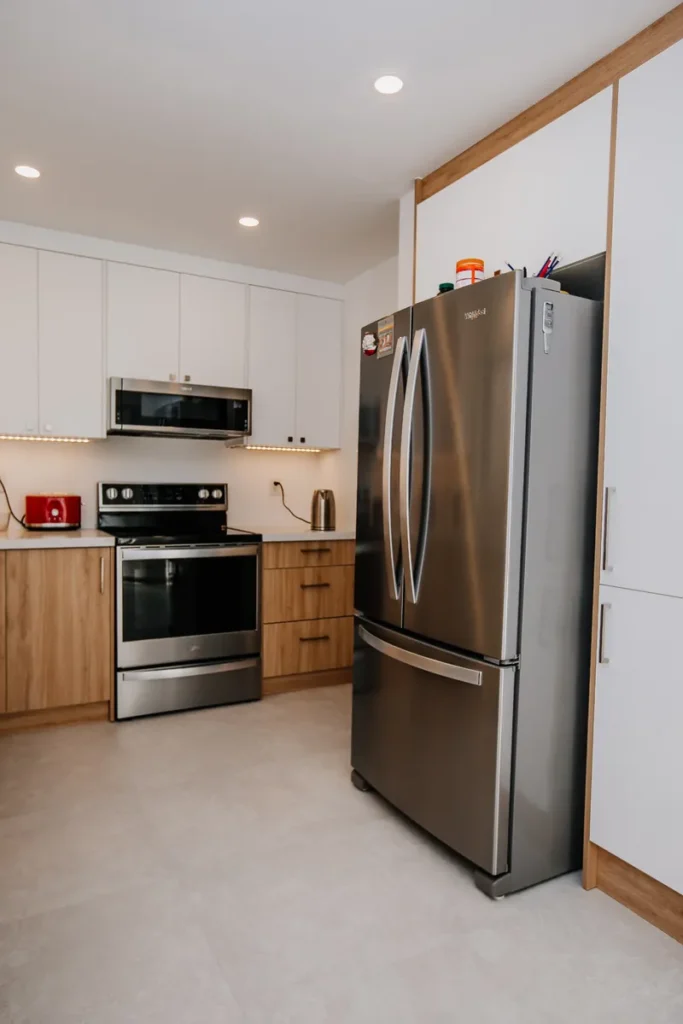 whirlpool french door fridge built flush with white pantry cabinetry after kitchen renovation in mississauga