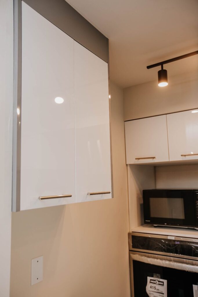 white gloss upper cabinets black track lighting scarborough condo kitchen renovation