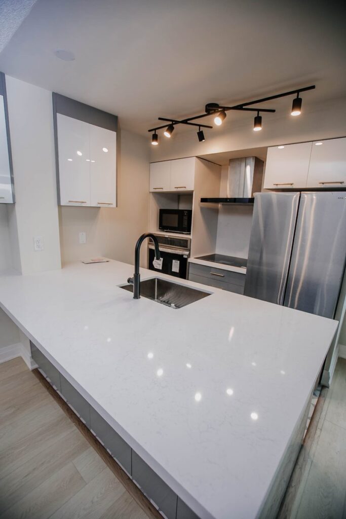 white quartz peninsula undermount sink matte black faucet scarborough condo kitchen