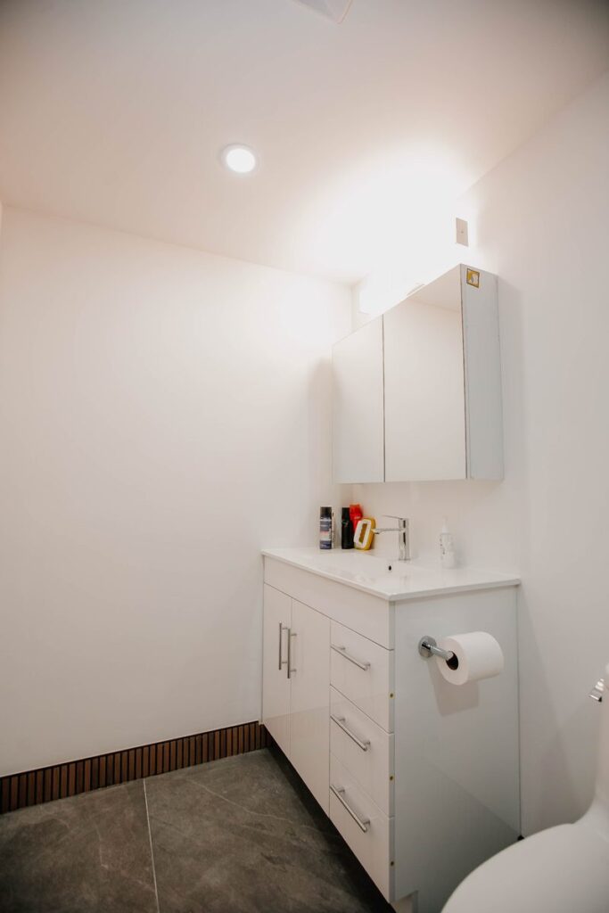 white vanity mirror cabinet slate look floor scarborough condo bathroom